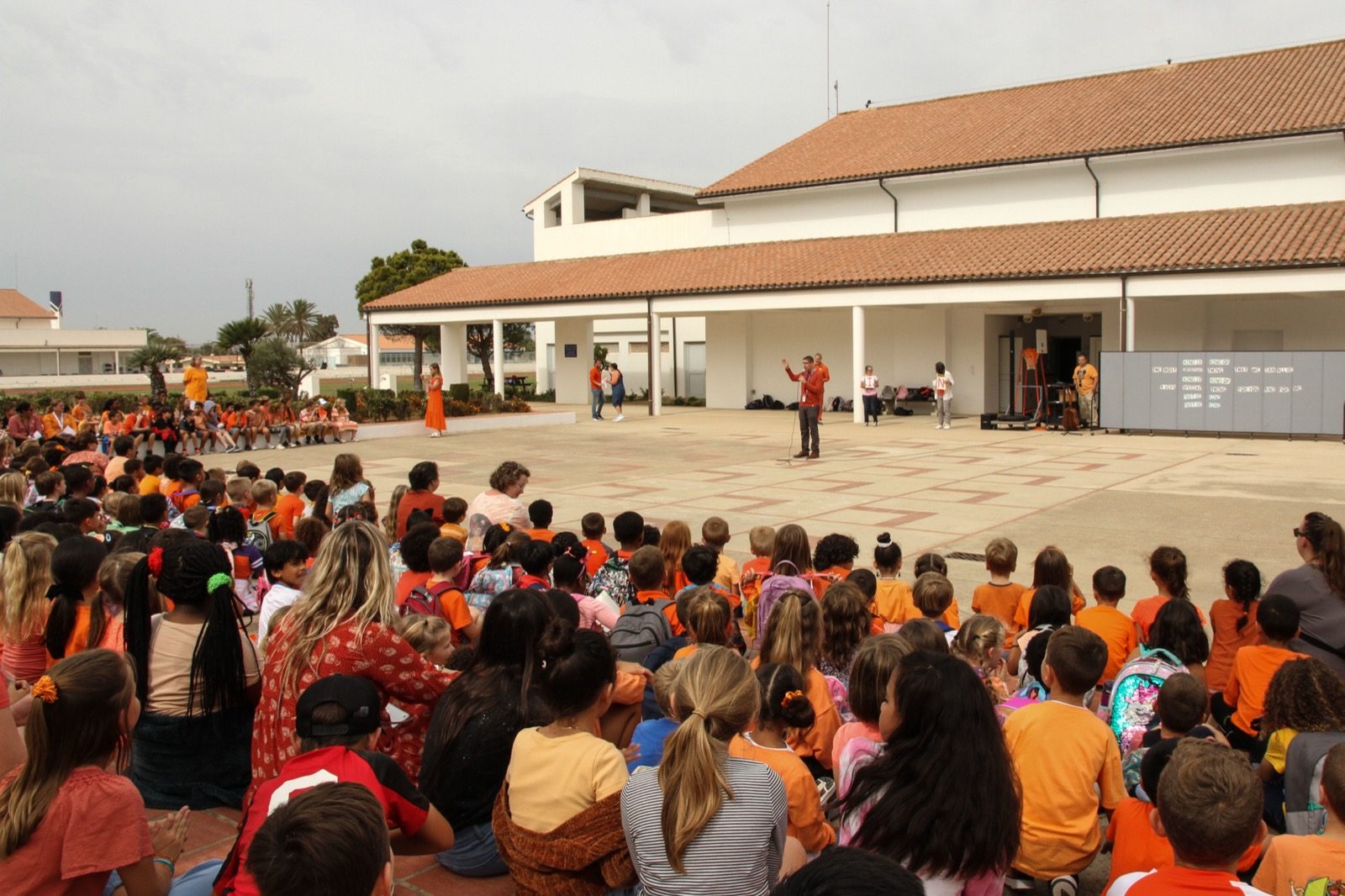 Students at Rota Elementary School in Spain gather for a Unity Day assembly, wearing orange to mark National Bullying Prevention Month