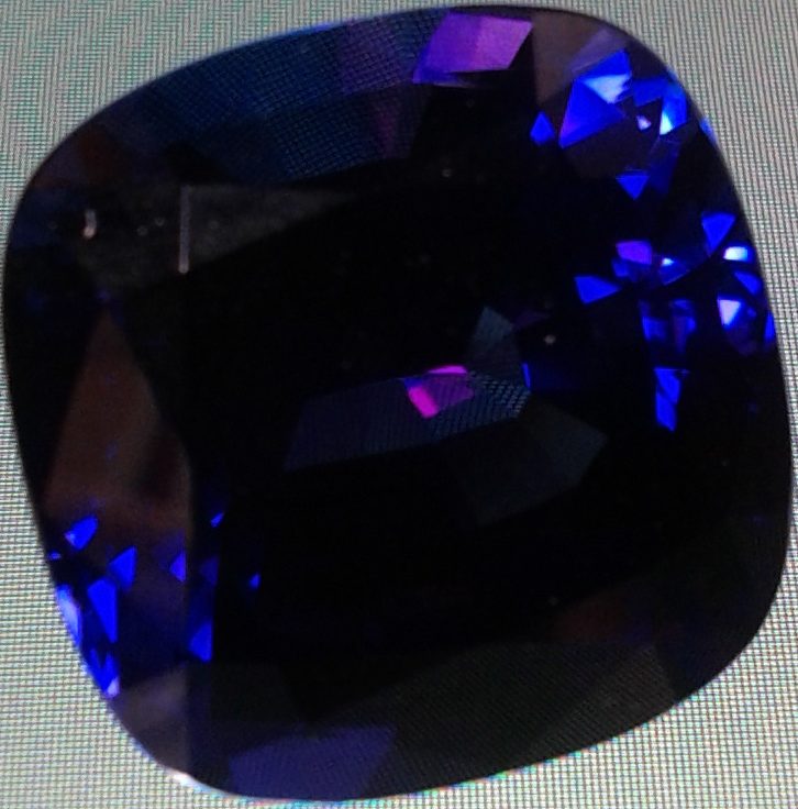 Trichroic tanzanite gemstone showing blue, violet, and purple faces