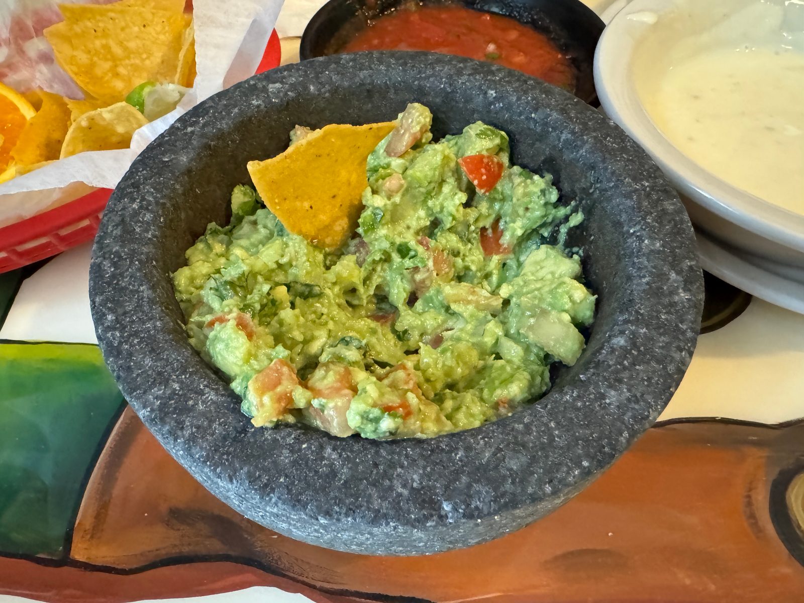 Guacamole served in a traditional stone molcajete at a Mexican restaurant