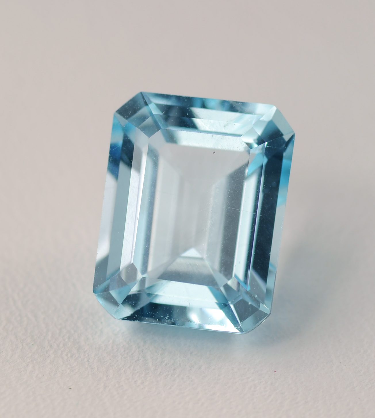 An emerald-cut blue topaz gemstone