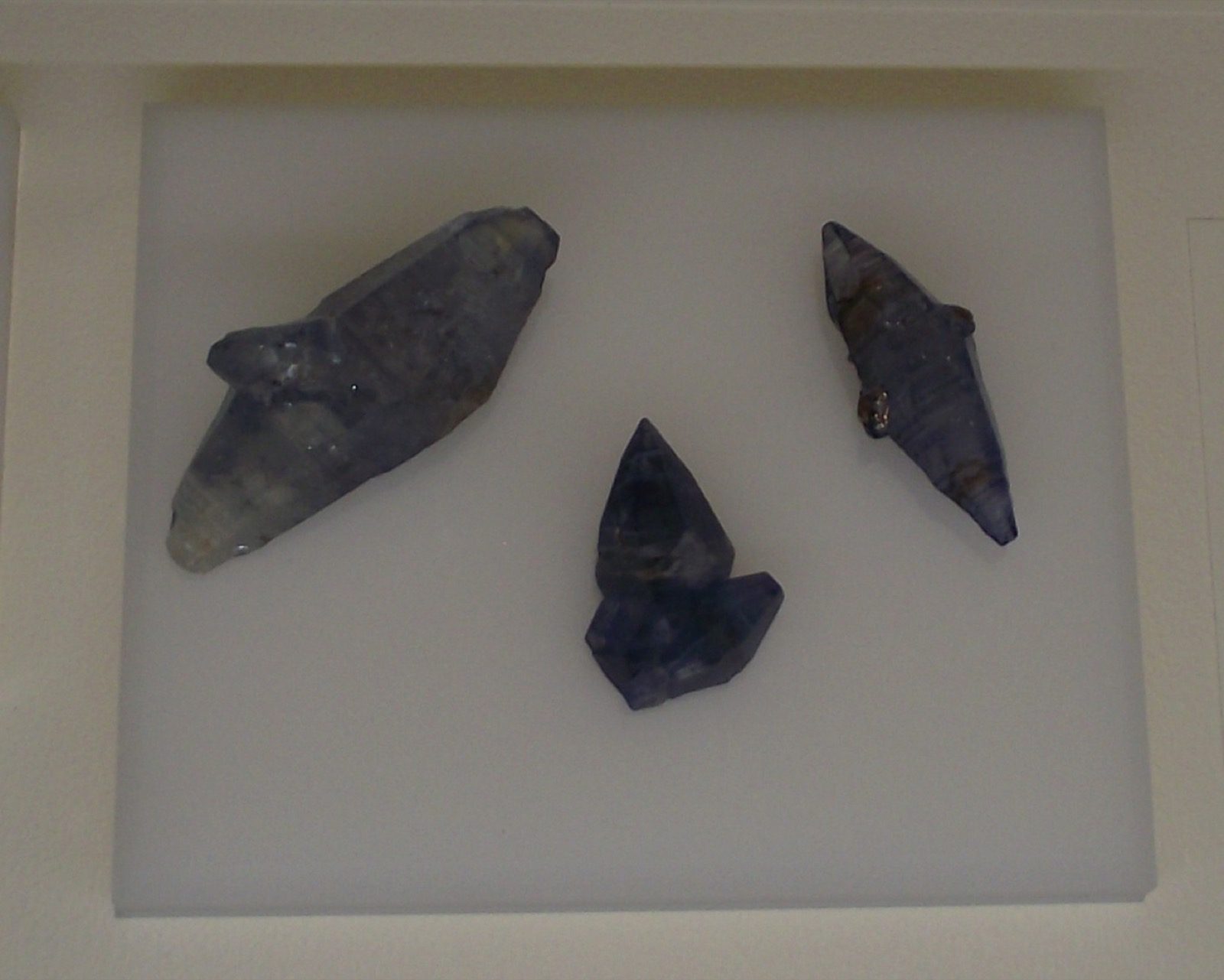 Three natural sapphire crystals from Sri Lanka and Myanmar, displayed at the San Diego Natural History Museum